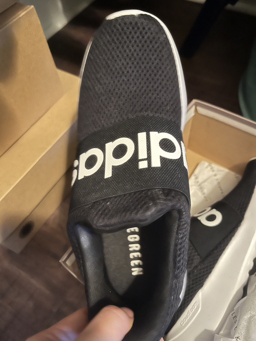 Black Adidas slip-on sneakers