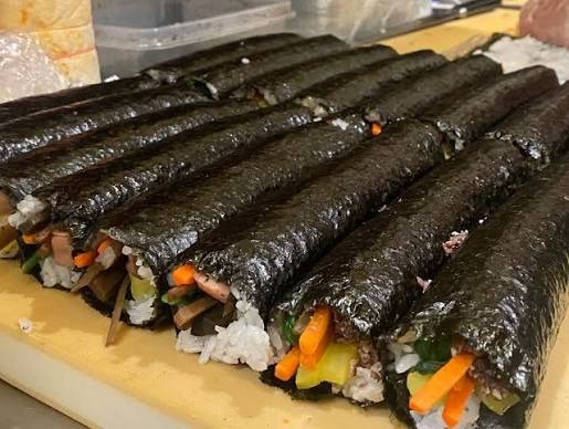 Authentic freshly rolled Korean gimbap brushed with sesame oil at E-Mo Kimbap in Koreatown