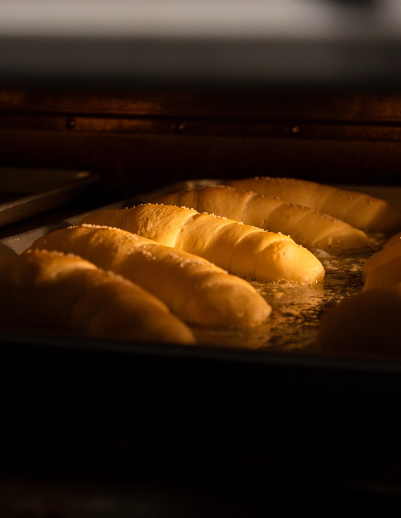 Fresh salt bread rolls baking in the oven at Justin’s Salt Bread